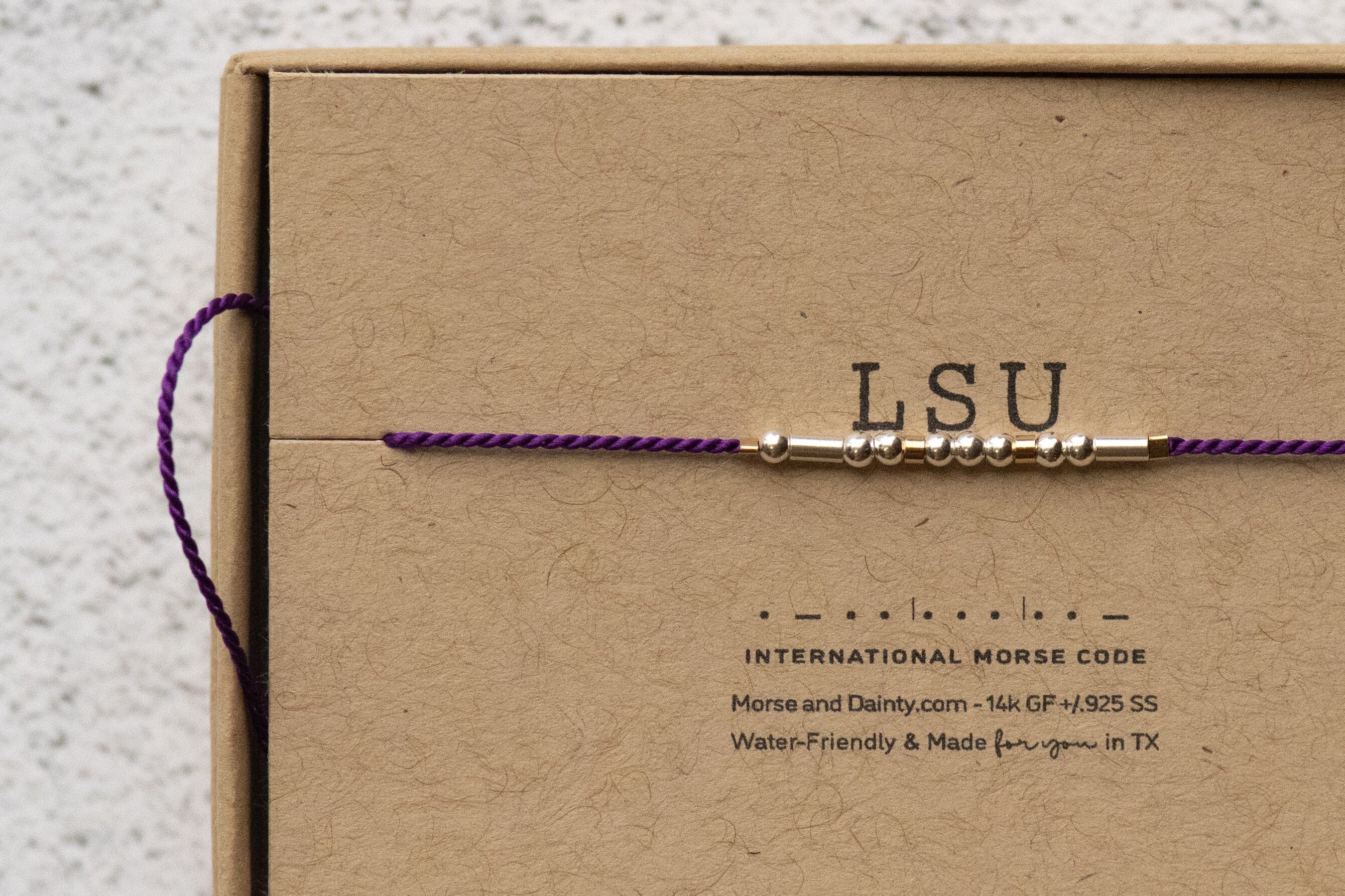 LSU Bracelet or Any College in Morse Code. Purple cord or choose from 20 colors. Silver and Gold Filled for Everyday Wear. Adjustable